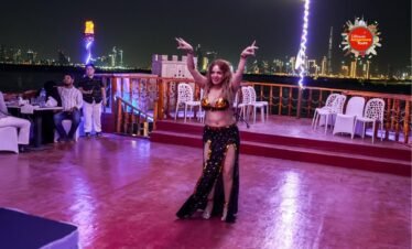 Guests enjoying live dance performance on dinner cruise